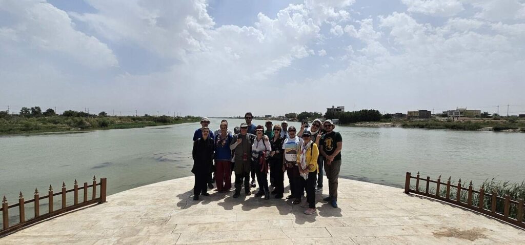 Tourist standing at Al-Multaqa in southern Iraq, overlooking the meeting point of the Tigris and Euphrates rivers as their waters converge to form the Shatt al-Arab near Basra.