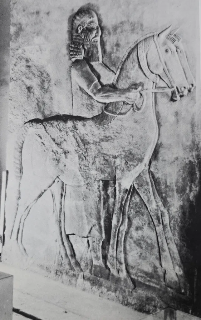 Relief showing an Assyrian groom leading a pair of horses. Traces of original paint are visible, from Khorsabad