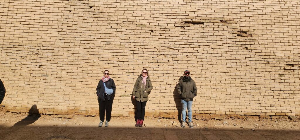 Tourists standing at the historic Babylon on private tours to Iraq