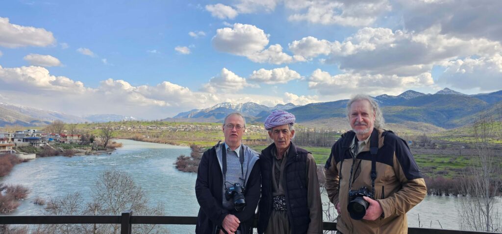 Group of tourists posing in scenic Kurdistan mountains on private tours to Iraq