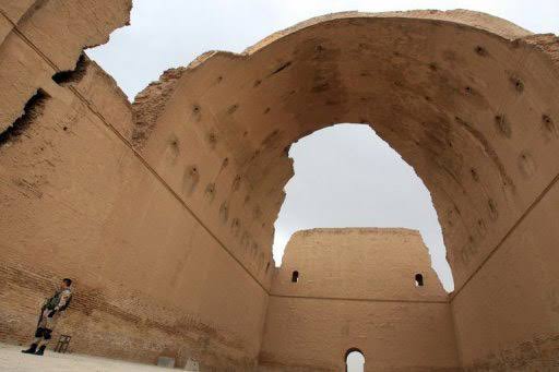 Close-up view of the monumental Taq Kasra at ancient Ctesiphon in Iraq, highlighting the enormous vaulted brick arch, layered masonry, weathered surfaces, and intricate architectural details preserved from the former Sasanian capital.