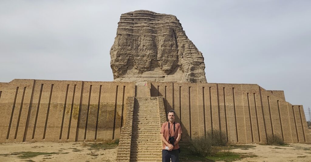 A traveler stands before the imposing remains of Dur-Kurigalzu, an ancient Kassite royal city established in Mesopotamia more than 3,000 years ago. The site's massive ziggurat and surrounding archaeological remains offer a remarkable glimpse into the architecture, religious traditions, and royal heritage of one of ancient Iraq's important civilizations.