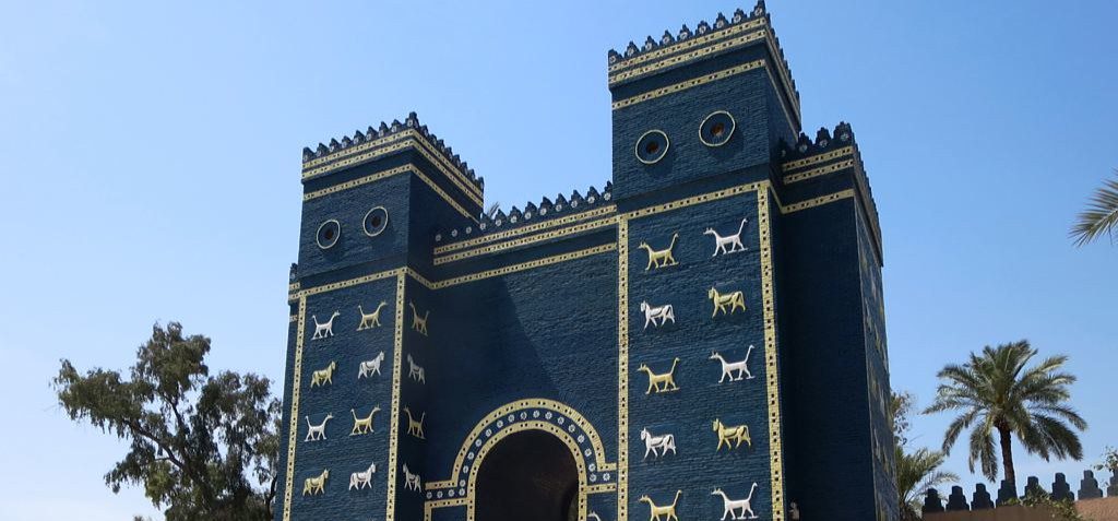 Ishtar Gate at the ancient city of Babylon in Iraq, featuring its imposing blue-toned walls and distinctive reliefs of lions, bulls, and mythical creatures from Babylonian art
