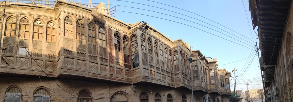 Traditional Shanasheel houses in Basra, southern Iraq, featuring ornate wooden balconies, carved latticework, projecting upper floors, and distinctive heritage architecture found in the historic neighborhoods of the city