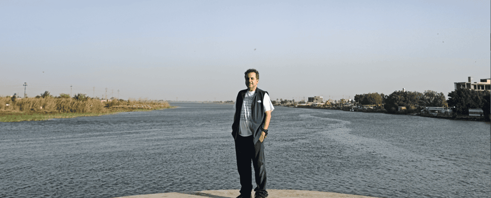Tourist standing at Al-Multaqa in Al-Qurnah, southern Iraq, where the Tigris and Euphrates rivers meet to form the Shatt al-Arab, surrounded by the scenic riverside landscape of Mesopotamia